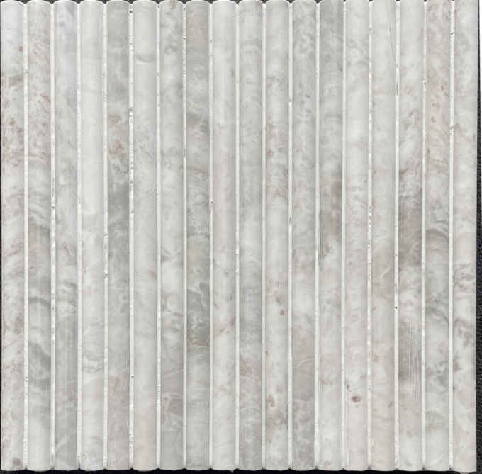 The wavy grooved wall is decorated with Pearl white marble